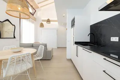 a kitchen and living room with a table and chairs at Ca Celieta Beach IV in Valencia