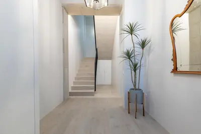 a hallway with a staircase and a potted plant at Ca Celieta Beach IV in Valencia