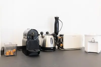 a counter top with a coffee maker and other appliances at Ca Celieta Beach IV in Valencia