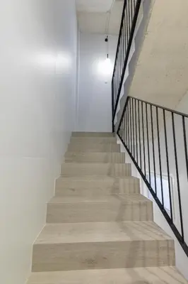 a staircase in a building with white walls and wooden floors at Ca Celieta Beach IV in Valencia