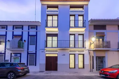 a blue building with cars parked in front of it at Ca Celieta Beach IV in Valencia