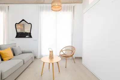 a living room with a couch and a table at Ca Celieta Beach IV in Valencia