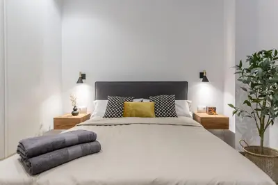 a bedroom with a large white bed with pillows at Suite Deluxe Valencia - AIORA Apartments in Valencia