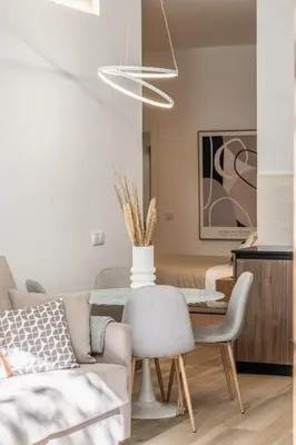 a living room with a table and a couch at Suite Deluxe Valencia - AIORA Apartments in Valencia