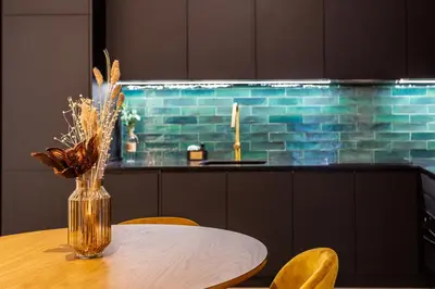 a kitchen with a table and a vase with feathers at Suite Deluxe Valencia - AIORA Apartments in Valencia