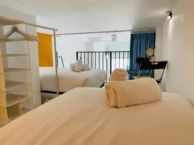 a bedroom with two beds with towels on top of it at Modern Designed Loft in Russafa (SOHO) in Valencia