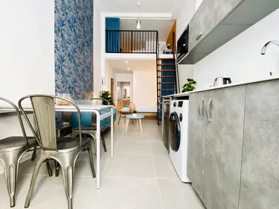 a kitchen and dining room with a table and chairs at Modern Designed Loft in Russafa (SOHO) in Valencia