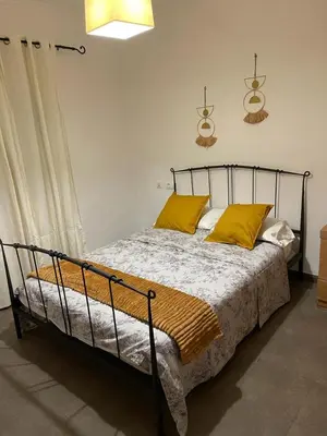 a bedroom with a bed with yellow pillows on it at UIM Mediterraneo PB Miguel Hernandez Wifi in Puerto de Sagunto