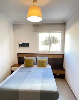 a bedroom with a large bed and a window at UIM Mediterraneo PB Dolores Ibarruri Wifi in Puerto de Sagunto