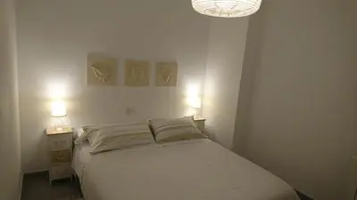 a bedroom with a bed and two night stands with lamps at Playa y Montaña Faura-Valencia in Faura