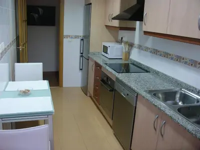 a small kitchen with a sink and a microwave at Playa y Montaña Faura-Valencia in Faura