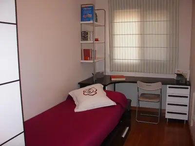a small room with a bed and a desk at Playa y Montaña Faura-Valencia in Faura