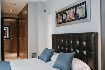 two beds with black headboards in a room at Citizentral Juristas in Valencia