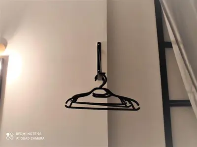a black hanger hanging from a wall at lifecoliving valencia loft BR in Valencia