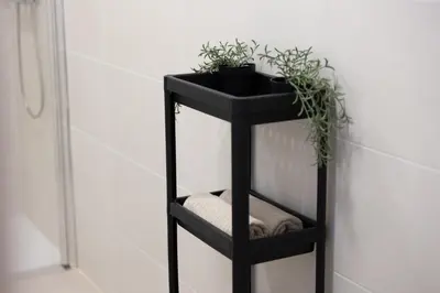 a black shelf with plants on it in a bathroom at Spacious OCEANOGRAFIC Flats Valencia in Valencia