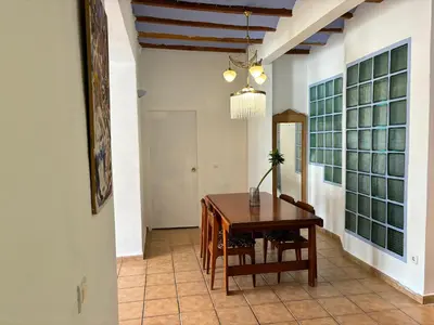 a dining room with a wooden table and chairs at Piso en Vall de Almonacid con vistas, aire acondicionado, Wifi y Smart TV in Vall de Almonacid