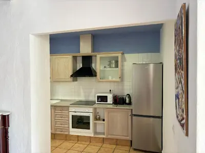 a kitchen with a stainless steel refrigerator and cabinets at Piso en Vall de Almonacid con vistas, aire acondicionado, Wifi y Smart TV in Vall de Almonacid