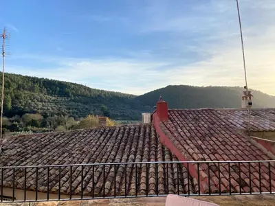 a roof of a building with a mountain in the background at Piso en Vall de Almonacid con vistas, aire acondicionado, Wifi y Smart TV in Vall de Almonacid