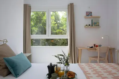 a bedroom with a bed with a large window at SingularStays Tinglado in Valencia