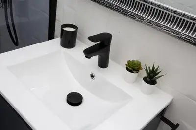 a sink with a black faucet on a white counter at SingularStays Tinglado in Valencia