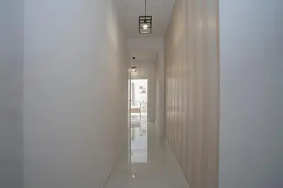 a hallway with white walls and a mirror on the wall at SingularStays Tinglado in Valencia