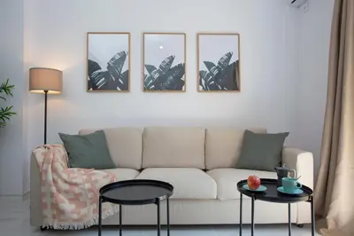a living room with a couch and four pictures on the wall at SingularStays Tinglado in Valencia