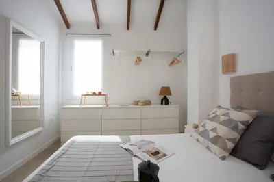 a white room with a bed and a window at SingularStays Vivons in Valencia