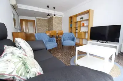 a bedroom with a large bed with two pairs of shoes on it at Playa Malvarrosa House in Valencia
