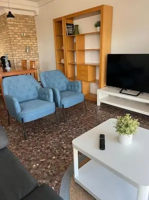 a wooden cabinet with three pictures on the wall at Playa Malvarrosa House in Valencia