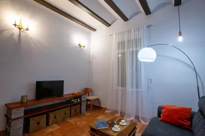 a living room with a couch and a tv at Cozy apartment near the center, Torres de Serrano in Valencia
