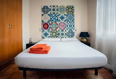 a bedroom with a bed with orange towels on it at Cozy apartment near the center, Torres de Serrano in Valencia