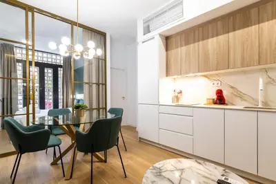 a kitchen and dining room with a glass table and chairs at Anelsa Torres de Serranos 3 in Valencia