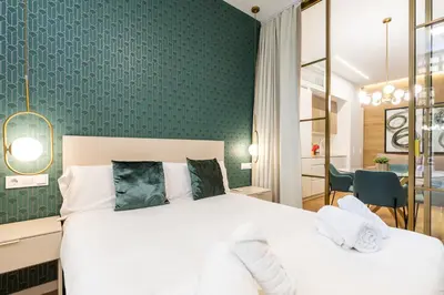 a bedroom with a bed and a green wall at Anelsa Torres de Serranos 3 in Valencia