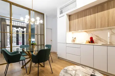 a kitchen and dining room with a table and chairs at Anelsa Torres de Serranos 3 in Valencia