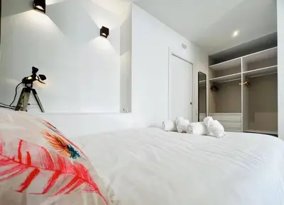a bedroom with a large white bed with a camera on it at Exclusive LOFT in Ruzafa (SOHO) in Valencia