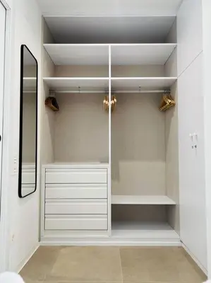 a walk in closet with a mirror and white cabinets at Exclusive LOFT in Ruzafa (SOHO) in Valencia