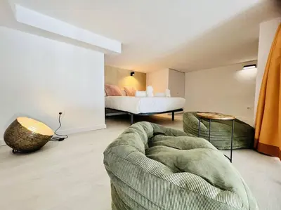 a living room with a couch and a bed at Exclusive LOFT in Ruzafa (SOHO) in Valencia