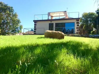 a house in the middle of a field of grass at Casa Navajas in Jérica