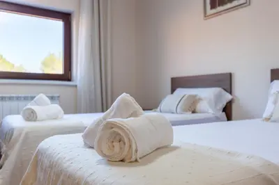 a hotel room with two beds with towels on them at Casa Navajas in Jérica