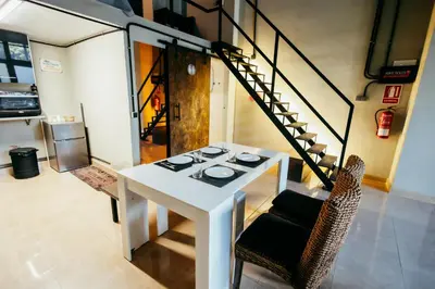 a dining room with a white table and chairs at Apartment Ruzafa Roots, 12 min to Centre, Smart TV, Wine in Valencia