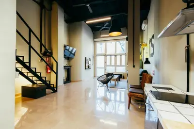 a living room with a hallway with a staircase and a living room at Apartment Ruzafa Roots, 12 min to Centre, Smart TV, Wine in Valencia