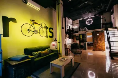 a living room with a couch and a bike on the wall at Apartment Ruzafa Roots, 12 min to Centre, Smart TV, Wine in Valencia