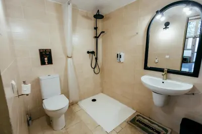 a bathroom with a toilet and a sink at Apartment Ruzafa Roots, 12 min to Centre, Smart TV, Wine in Valencia