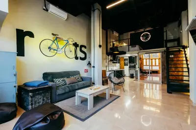a living room with a couch and a bike on the wall at Apartment Ruzafa Roots, 12 min to Centre, Smart TV, Wine in Valencia