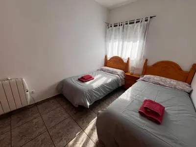 a bedroom with two beds with red towels on them at Apartamento La Ermita in Chulilla