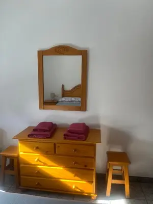 a wooden dresser with a mirror on a wall at Apartamento La Ermita in Chulilla
