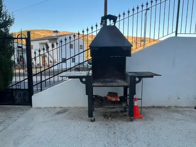 a grill sitting next to a fence with a staircase at Apartamento La Ermita in Chulilla