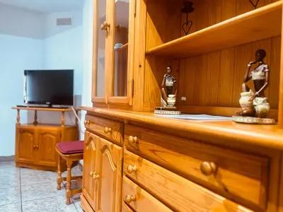 a wooden cabinet with two statues on top of it at Apartamento La Ermita in Chulilla
