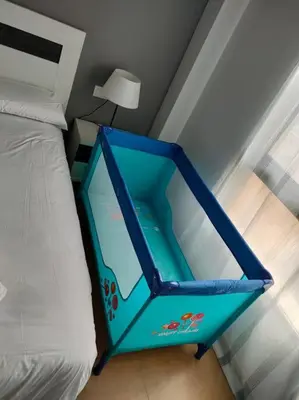 a blue container sitting on a bed in a bedroom at MAGNIFICO APARTAMENTO · PLAYA CANET DE BERENGUER in Canet de Berenguer