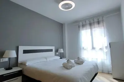 a bedroom with a large bed with two stuffed animals on it at MAGNIFICO APARTAMENTO · PLAYA CANET DE BERENGUER in Canet de Berenguer